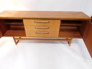A Portwood Furniture vintage teak sideboard, with three central drawers flanked by a pair of cupboard doors, raised on U shaped ends, 75cm high, 184cm wide, 44cm deep. - 5