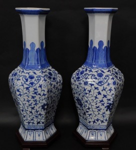 A pair of Chinese blue and white hexagonal baluster vases, decorated in a floral blue and white pattern with lappet shoulders, 62cm high with integral base.