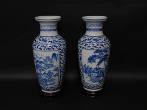 A pair of Chinese porcelain baluster vases, having blue and white landscape decoration, 54cm high with attached base. - 2