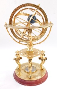 A brass orrery, with an astrological plate, raised on four supports above a table type base on three lion's paws supports, above a circular base inset with a compass, 26cm high. (AF) - 2