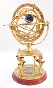 A brass orrery, with an astrological plate, raised on four supports above a table type base on three lion's paws supports, above a circular base inset with a compass, 26cm high. (AF) - 4