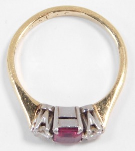 An 18ct gold ruby and diamond three stone ring, the diamonds approximately 0.25ct, size L, 2.7g. - 2
