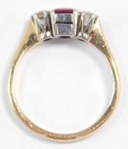 An 18ct gold ruby and diamond three stone ring, the diamonds approximately 0.25ct, size L, 2.7g. - 3