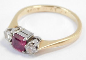 An 18ct gold ruby and diamond three stone ring, the diamonds approximately 0.25ct, size L, 2.7g. - 4