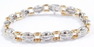 A baguette diamond bracelet, set in a white oval and yellow square metal link bracelet, stamped 14k, on a snap clasp, approximately 2ct, 18.3g.