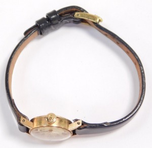 An Omega 9ct gold cased lady's wristwatch, circular champagne dials with gold batons, on a leather strap. - 2