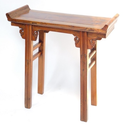 A Chinese or Korean elm small altar table, with plank top and raised sides, on channeled legs with scroll carved brackets, 85cm high, 84cm wide.