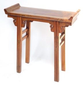 A Chinese or Korean elm small altar table, with plank top and raised sides, on channeled legs with scroll carved brackets, 85cm high, 84cm wide.