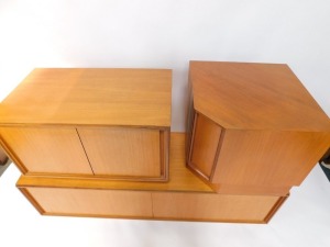 An E Gomme Ltd 1970's teak low corner unit, in three sections, with sliding doors, on a plinth, each 49cm high. - 2