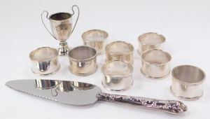 A set of six Elizabeth II silver napkin rings, by Francis Howard Ltd, Birmingham 1962, with a pair of additional napkin rings, a commemorative cup and a silver handled cake slice, 5.32oz all in. - 3