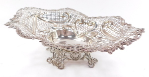 A Victorian silver centrepiece bowl, having elaborate scrolled and floriate rim, surrounding a multi patterned pierced lattice work design, with heart shaped moulded scrolls, surmounted by ribbon bows, with centre oval reservoir, raised upon a quadriparti - 2
