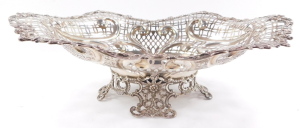 A Victorian silver centrepiece bowl, having elaborate scrolled and floriate rim, surrounding a multi patterned pierced lattice work design, with heart shaped moulded scrolls, surmounted by ribbon bows, with centre oval reservoir, raised upon a quadriparti - 3