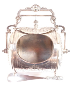 A Victorian silver plated biscuit barrel, of barrel form, embossed with acanthus leaves and with engraved decoration, with swing handle, 21cm wide, together with a shoe horn with silver handle, with floral and foliate embossed decoration, London 1872. (2) - 3