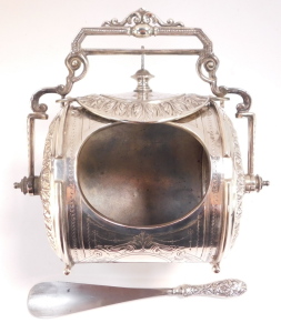 A Victorian silver plated biscuit barrel, of barrel form, embossed with acanthus leaves and with engraved decoration, with swing handle, 21cm wide, together with a shoe horn with silver handle, with floral and foliate embossed decoration, London 1872. (2) - 4
