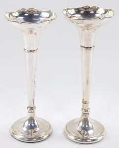 Two George V silver bud vases, having a moulded bowl, above a tapering cylindrical stem with flared base, both with loaded bases, 7cm and 8cm respectively. - 2