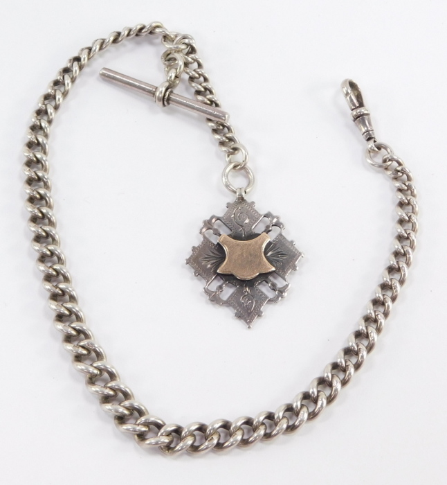 An Edwardian silver graduated curb link watch chain, terminating upon T bar and watch link, with additional fob chain having diamond shaped fob, with vacant cartouche, Herbert Bushell, Birmingham 1902, 1.98oz all in, total length 34cm.