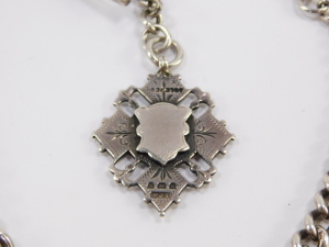 An Edwardian silver graduated curb link watch chain, terminating upon T bar and watch link, with additional fob chain having diamond shaped fob, with vacant cartouche, Herbert Bushell, Birmingham 1902, 1.98oz all in, total length 34cm. - 3