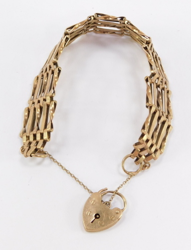 A 9ct gold gate bracelet, formed of nine gate sections with padlock clasp and security chain, 18.7g, 24cm long.