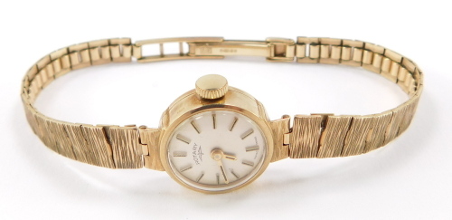 A lady's 20thC 9ct gold Rotary cocktail wristwatch, having cream dial with applied stick markers and pencil hands, with knurled crown, bark effect reticulated bracelet, 15g, 16cm long.