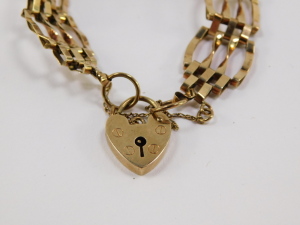 A 9ct gold gate link bracelet, comprising nine gate sections, security chain and padlock clasp, 9.8g, 20cm long. - 2