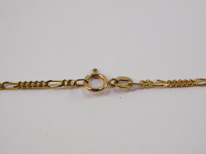 A Continental pendant, having pear cut garnet, surrounded by seed pearls, surmounted by fluted fitting, in yellow metal, with associated Italian fancy link chain marked 9ct, total length 53cm . - 4