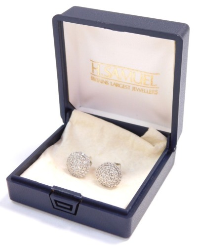 A pair of diamond cluster earrings, in a concentric circle design, in white metal stamped 585.