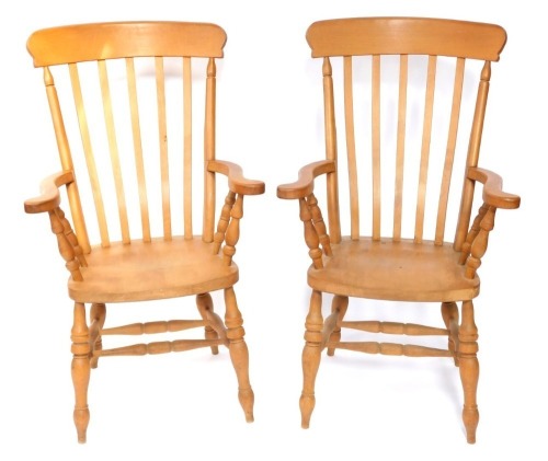 A pair of beech Windsor type lath back open armchairs, each with a solid seat, on turned legs and H stretcher.