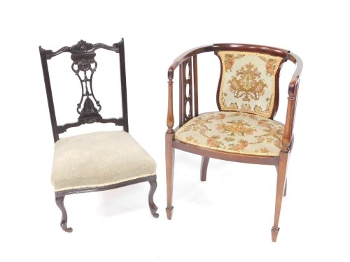 An Edwardian mahogany tub shaped chair, with padded back and seat, on square tapering legs, together with an early 20thC ebonsied nursing chair, on cabriole legs, with ceramic castors. (2)