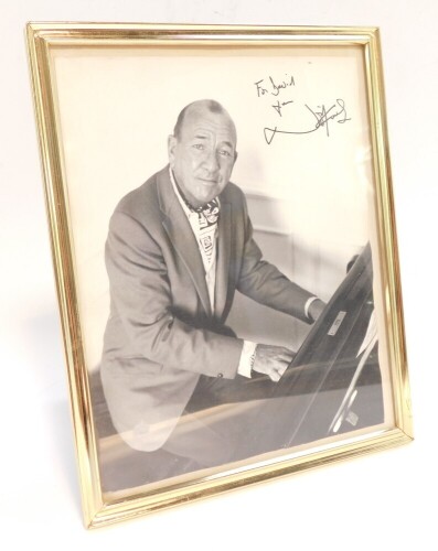 A signed photograph of Sir Noel Coward, dedicated "for David from Noel Coward", in a strut frame.