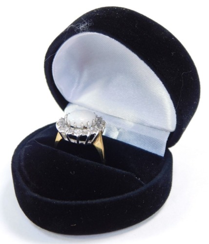 A 9ct gold and white opal ring, in a surround of cz, size L, 2.8g.