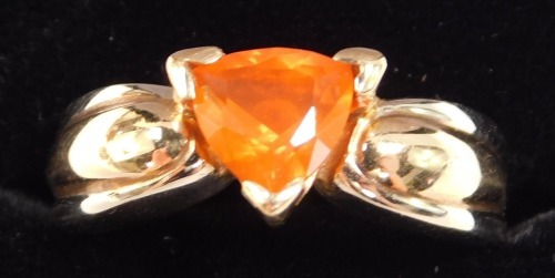 A fire opal ring, trilliant cut, set in yellow metal stamped 14k, approximately 1ct, size M, 6.60g.