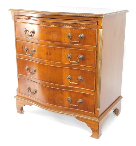A mid 20thC yew serpentine bachelors chest, of four drawers, 77cm high, 70cm wide, 47cm deep.