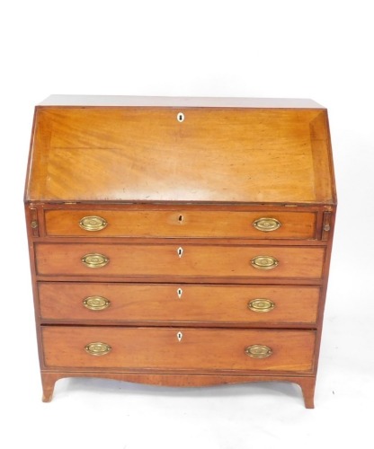 A George III mahogany bureau, the fall flap opening to reveal a central door with a shell patera, flanked by eight recesses over four short and two long drawers, four long graduated drawers, raised on bracket feet, 106.5cm high, 102cm wide, 52cm deep.