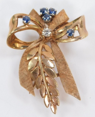 A 9ct gold sapphire and diamond brooch, in a bow and branch form, 7.9g.