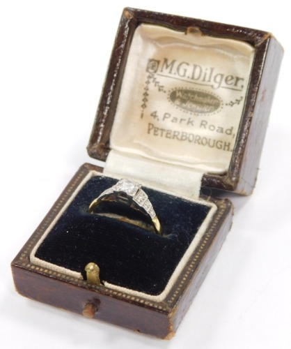 An 18ct gold platinium and diamond solitaire ring, in an illusion setting, approx 1/8ct, size O, 2.6g.