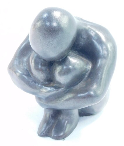 A modernist grey stone metal figure of a crouching figure, 8.5cm high.
