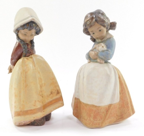 Two Lladro figures modelled as children, 21cm high.