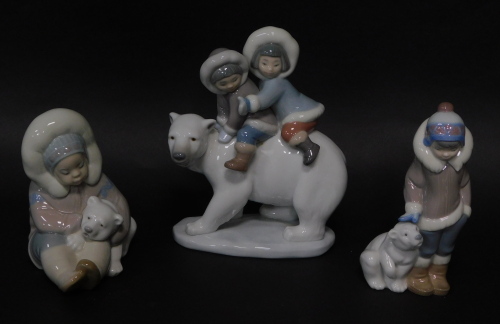 Three Lladro porcelain figures of Eskimo children with Polar bears, the tallest 18cm high.