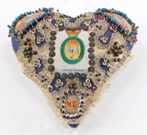 A WWI sweetheart's pin cushion, decorated with The Suffolk Regiment badge and 'Forget Me Not', 18cm high.