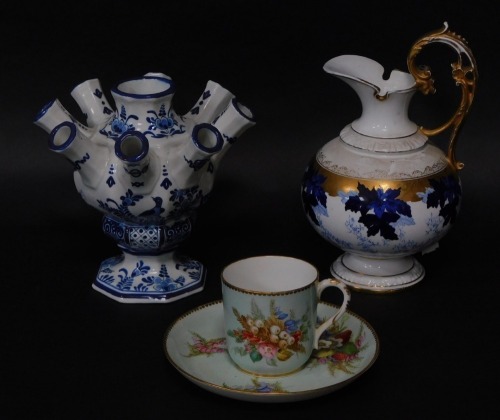 A Kerr & Binns Worcester porcelain coffee cup and saucer, Delft tulipiere and a Heubach Gebruder late 19thC blue and white jug with gilt handle, 19cm high. (3)