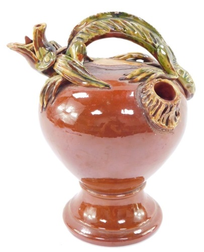 A 19thC art pottery moulded and glazed terracotta serpent wine ewer, 24cm high.
