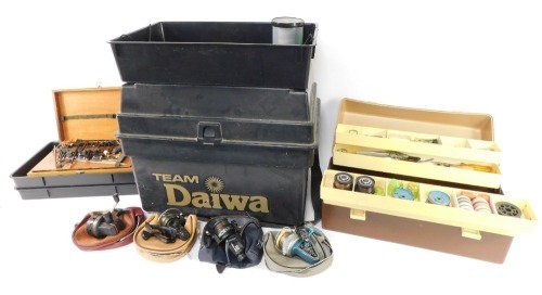 A Team Daiwa fishing box stool seat, with a selection of reels, floats, flies, etc. (a quantity)