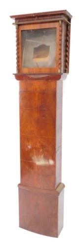 A Continental Beidermeier style walnut clock case, with glazed hood embellished with spirally turned pillars, above a bowed door, 74.5cm high.