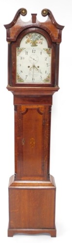 John Wilson, Peterborough. A mid 19thC longcase clock, the arched dial painted with baskets of flowers, fruit, etc., with an eight day four pillar movement, in an oak and mahogany crossbanded case, with oval paterae to the door, 208cm high.