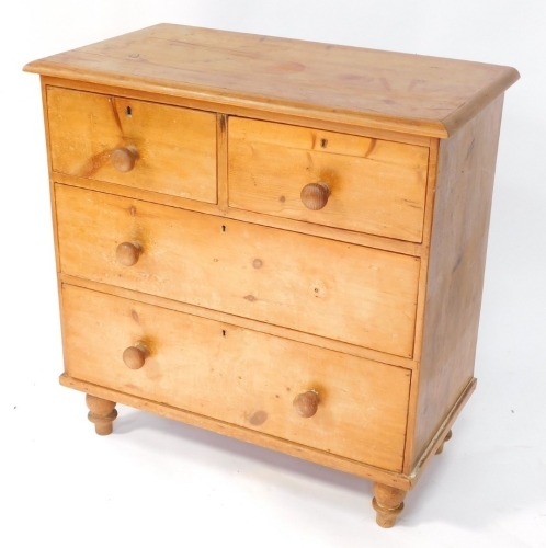 A Victorian pine chest of drawers, top with a moulded edge, above two short and two long drawers, each with turned wood handles on turned feet, 82cm wide.