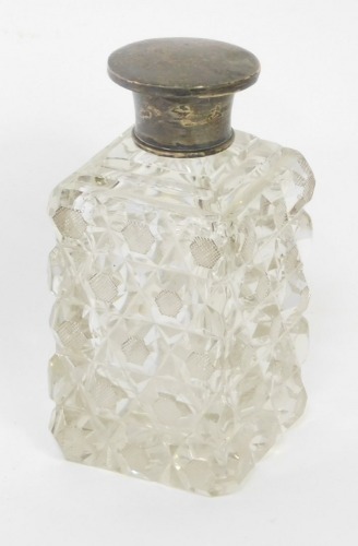 A late 19thC/early 20thC cut glass scent bottle, with a silver lid, and inner stopper, marks indistinct, 13cm high.