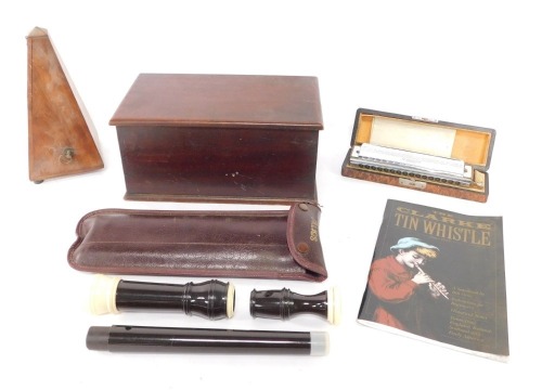 A group of items to include a Paquet metronome, a Hohner 64 Chromonica in fitted case, a mahogany box, and a recorder.
