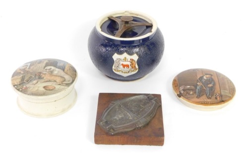 A Carlton ware tobacco jar, decorated with the crest of the City of Oxford, with two Pratt ware pot lids, On Guard, and Both Alike, together with a souvenir ashtray, Paris. (4)
