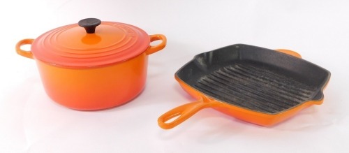 A Le Crueset burnt orange two handled iron casserole dish, and griddle pan. (2)