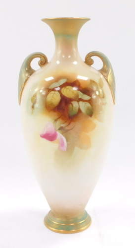 A Royal Worcester porcelain twin handled vase, painted with roses, on a blush ivory ground, printed marks in puce to underside and numbered 287, 30cm high. (AF)